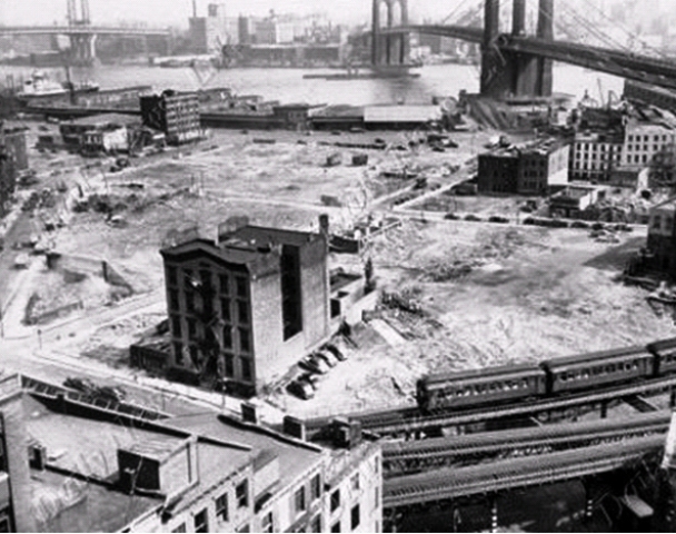 The old Oak Street station house of the Fourth Police Precinct was among the last structures to be removed when the Lower East Side neighborhood where cats once raided a butcher shop was demolished to make way for the Albert E. Smith housing project. This photo was taken around 1950.