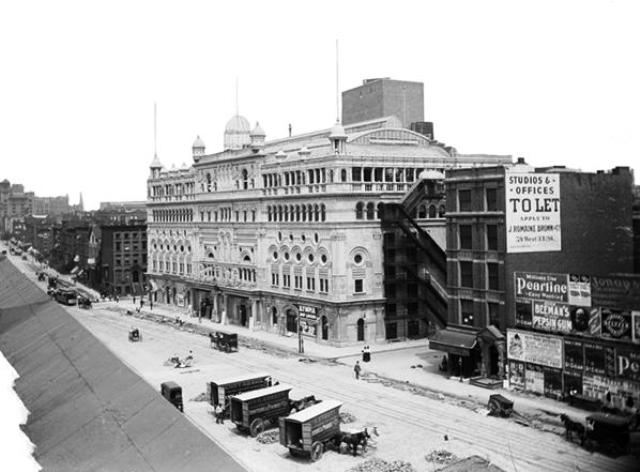 The massive, block-wide structure of Indiana limestone was designed by J. B. McElfatrick & Son. When it opened on November 25, 1895, the Olympia Theatre was only the second theater to open in what is now known as the Theater District. The first was the Empire Theatre, on the southeast corner of 40th Street and Broadway, which opened in 1893. Museum of the City of New York Collections