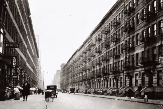 The Larsons and their Irish Setter, Dane, lived at 246 West 114th Street in Harlem, which was one of 36 five-story "Old Law" tenements on the block (pictured here in 1928). The Larson's building was on the south side of the street, near what was then still called Eighth Avenue (Frederick Douglas Boulevard). The fire escape was a favorite spot for Dane on warm nights. New York Public Library Digital Collections