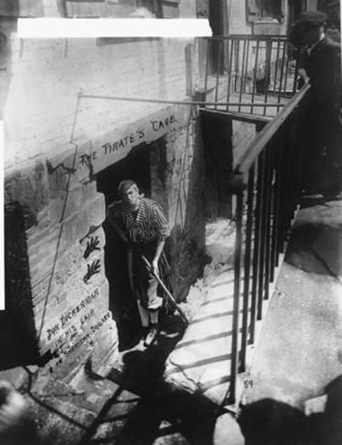 Don Dickerman in his lair, The Pirate's Cave, in Sheridan Square. The "tearoom" was in the cellar of an old, 4-story, molasses-colored brick building at 133 Washington Square.  Photo by Jessie Tarbox Beals, 1916