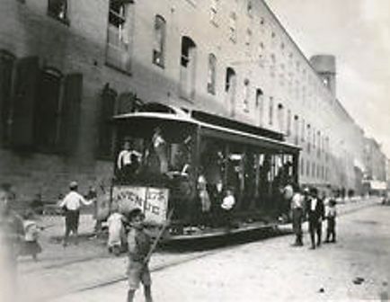 Children play in a stalled, empty trolley car that wasn't blown up during the Brooklyn Rapid Transit strike in July 1899. 