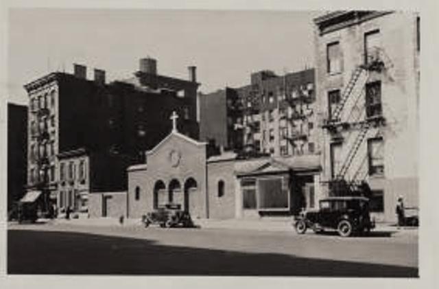 In this 1935 photo, 1335 York Avenue is the little two-story brick building to the left of the  Redemptionist Fathers of New York Church. The cottage was behind this building, hidden between the five- and six-story tenements. Museum of the City of New York 