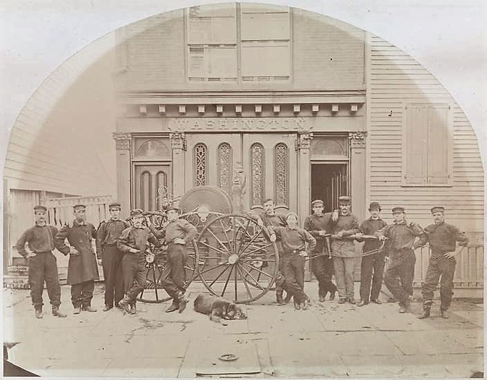 Organized in 1785, Brooklyn's first volunteer fire company, Washington Engine 1, was headquartered at Fulton and Front Streets. This photo of the firemen and their dog was taken 100 years later, in 1880. 