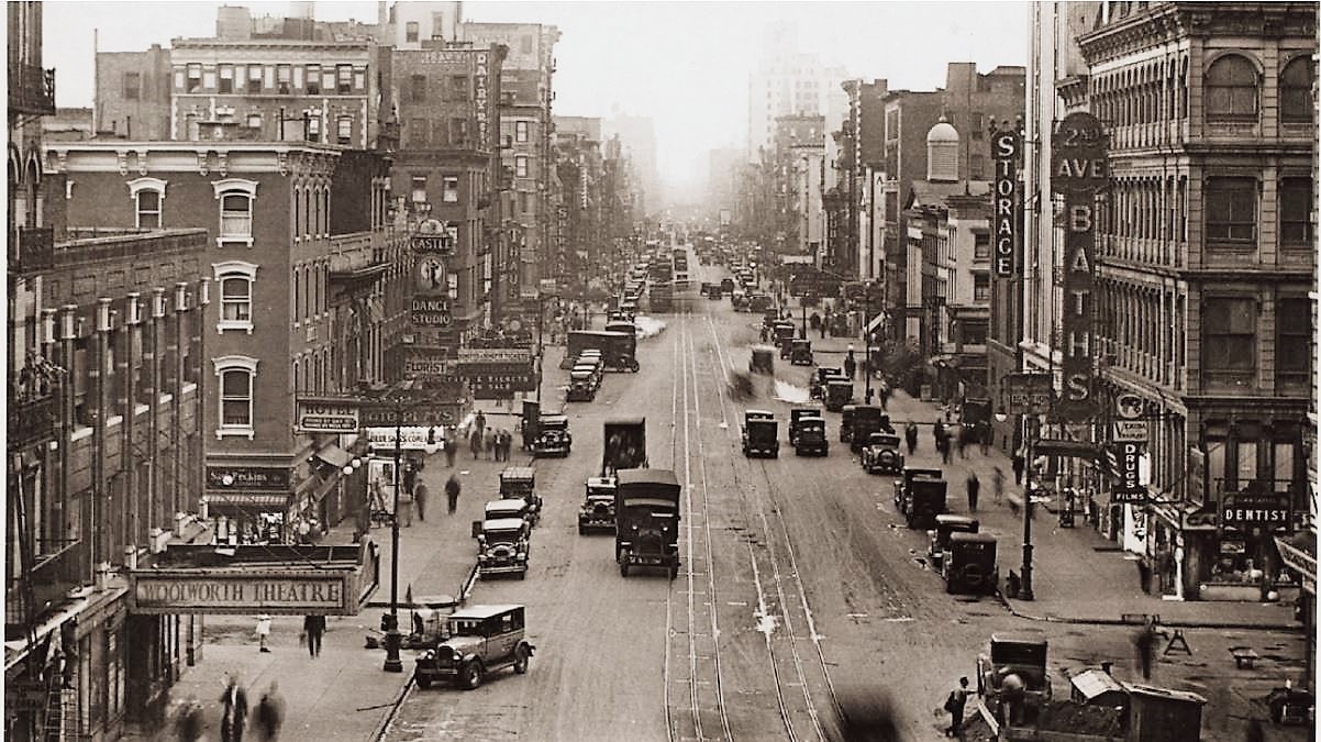 In this view of Second Avenue looking north from East 1st Street, the photo plays theater is visible on the left, a couple of buildings north of the Woolworth Theatre. New York Public Library Digital Collection