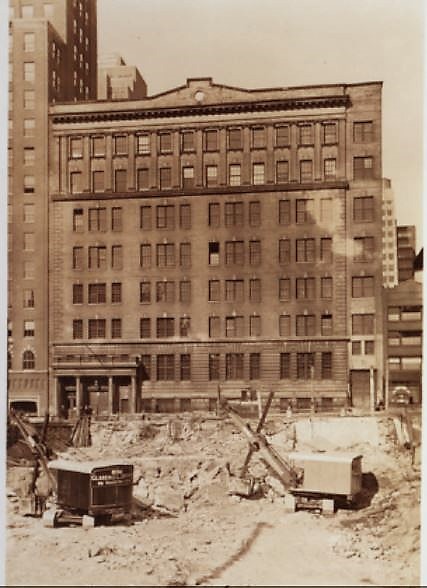 The American Express Company, 219-227 East 42nd Street, seen from the clearing where the Daily News building is about to be erected in 1929. NYPL Digital Collections