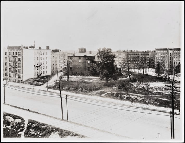 By 1913, when this photo was taken, numerous lots on the old Fox estate had been sold and developed, leaving the once grand mansion hanging on for dear life amid large tenement apartments. 