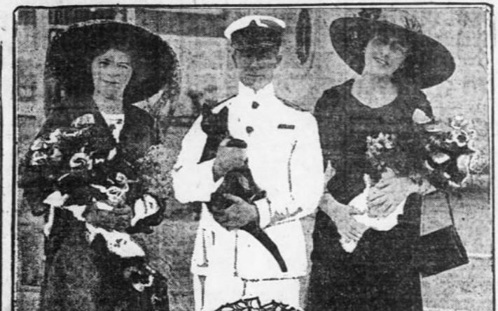 Miss Grace Kemble and Miss Irene Claire present Captain Rostron with a kitten just before the Carpathia set sail. 
