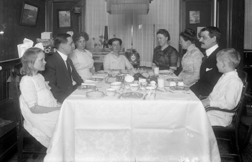 Hassler friends and relatives at dinner in 150 Vermilyea Avenue, Apartment 44, New York City: Mr. and Mrs. Lee, Gray, Hedda, William Gray Hassler, Harriet E. Hassler, Ethel Gray Magaw Hassler and Reddy (cat), undated.