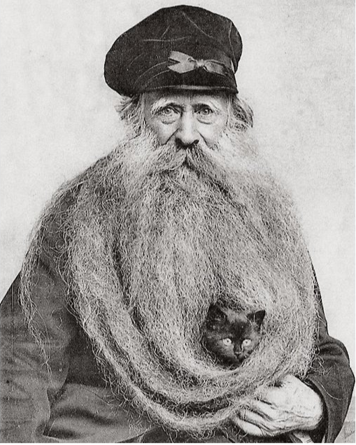 Could this be the Brooklyn Bridge Watchman with his cat? He was described as an old, grey-haired man "with a chinful of whiskers and a moustache," so let's pretend that it is! 