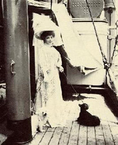 Princess Lwoff-Parlaghy with her two dogs on a ship in New York City. 