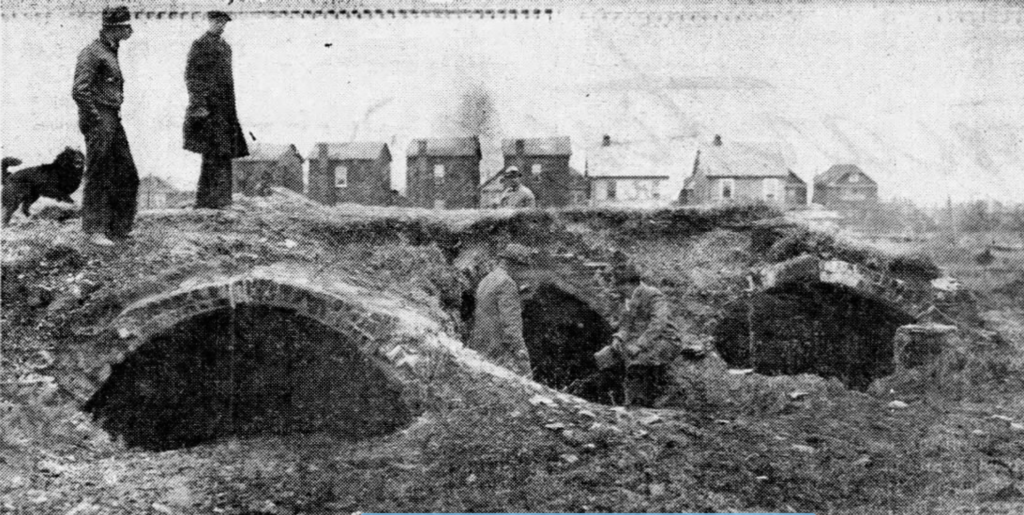 Workers (and perhaps a dog?) cutting through streets discovered the tunnels of the old Graham mansion in 1927. This view is probably looking from Flushing Bay across 26th Street. One theory is that the tunnels served as a stop on the Underground Railroad.