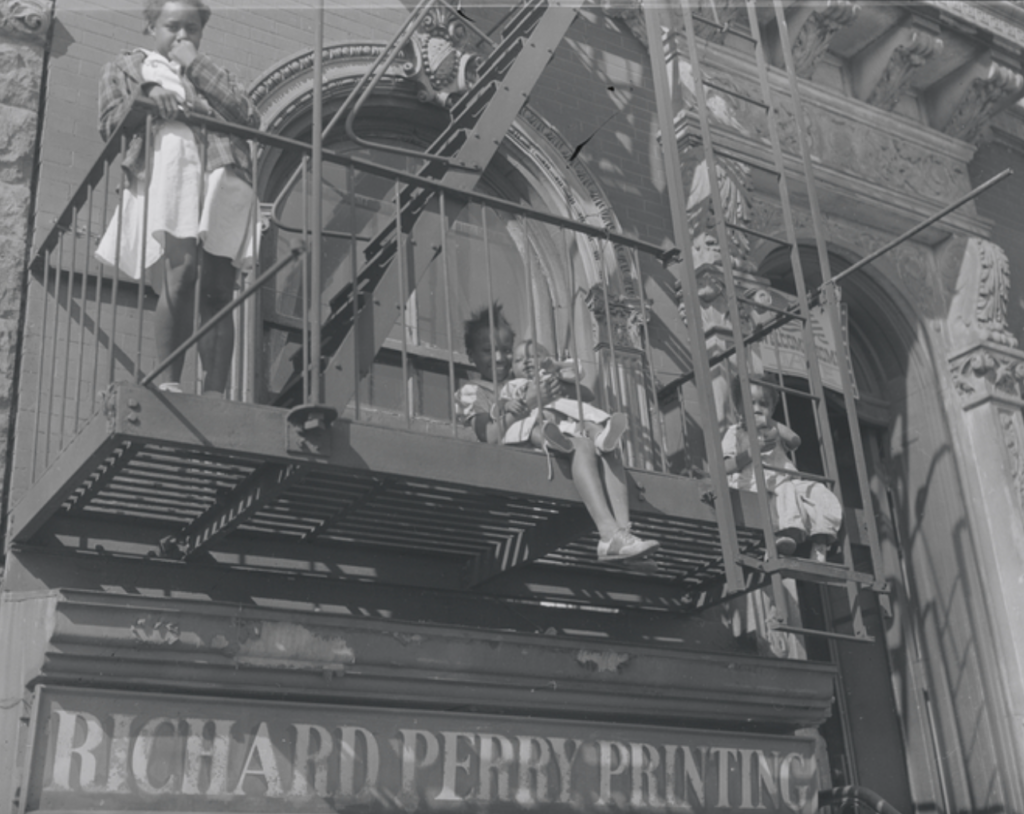 Children play on a fire escape. NYPL Digital Collections